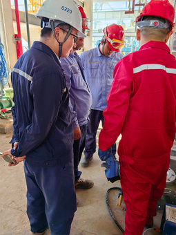Workers discussing filtration equipment installation on site