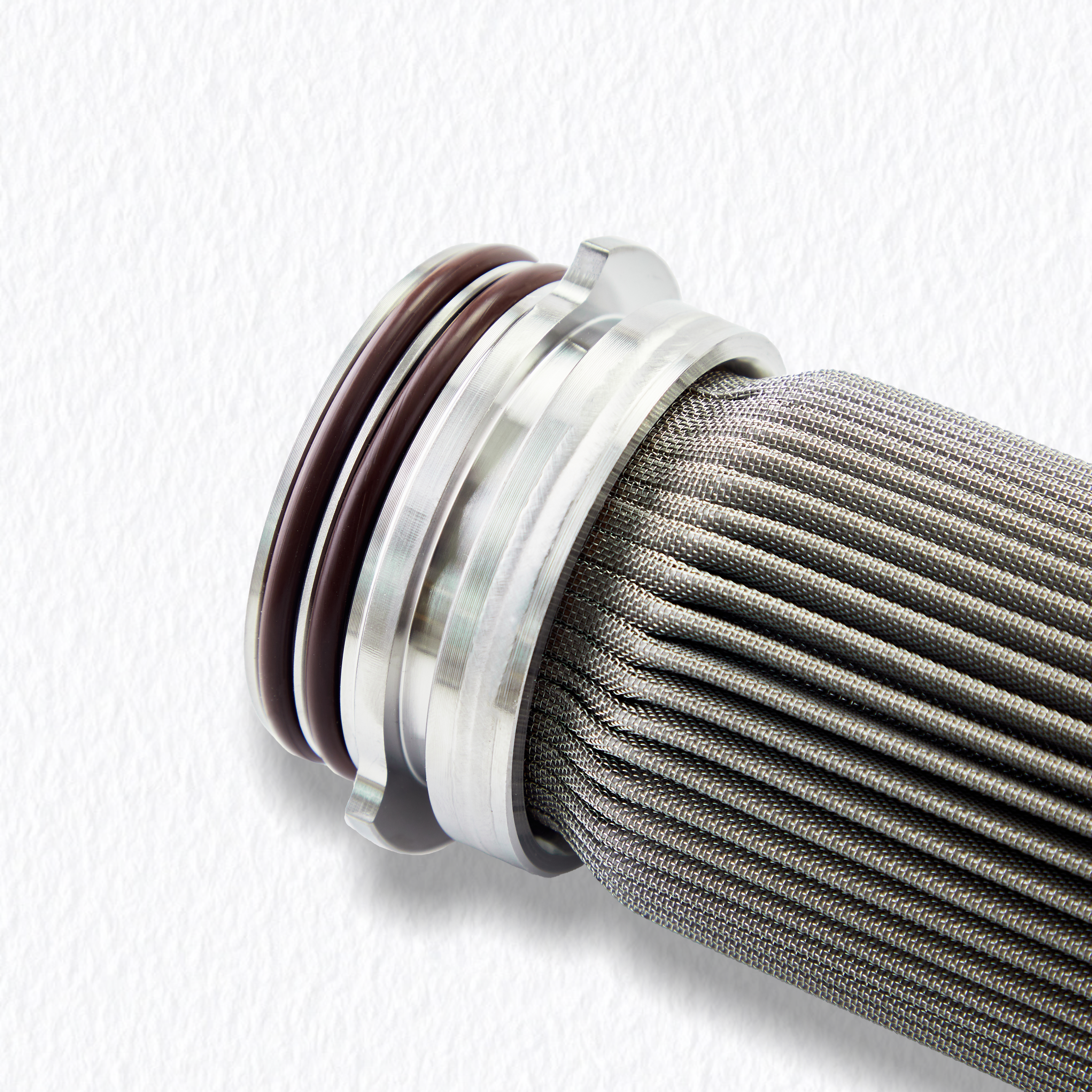 Welded connection detail of the stainless steel end adapter and pleated mesh, ensuring structural integrity under high differential pressure.